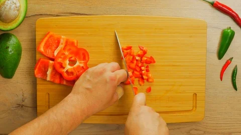 Red pepper chopping on a board Stockbeeldmateriaal 107539253