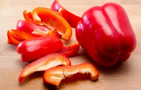 Red pepper cut on a board Stock Photos