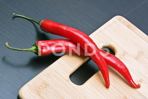 Red pepper on cutting board Stock Photos
