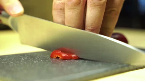 Red pepper cutting process. A man holds a vegetable in his hands. Stock Footage 135837368