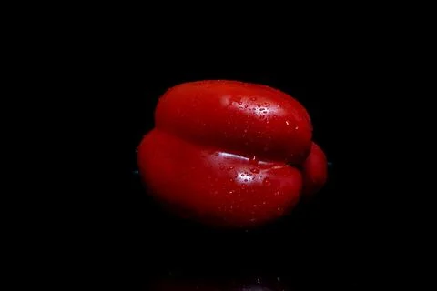 Red pepper with dew drops isolated on black. Stock Photos