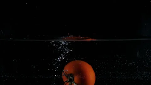 Red pepper dropped falling in water with lot of splashes Video stock 148737002