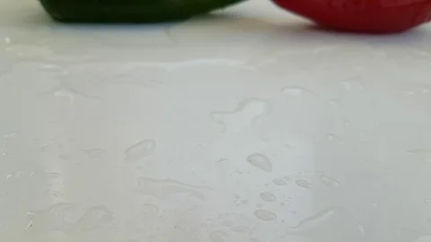 Red pepper drops on a white background slow-motion shot Stock Footage 90310805