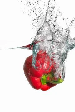 A red pepper falling into water Stock Photos