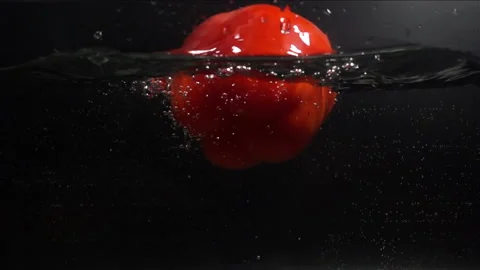 Red Pepper Falling in Water with Splash in Slow Motio Stock Footage 104726554