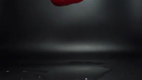 Red Pepper Falling in Water with Splash in Slow Motion Stock Footage 104726580