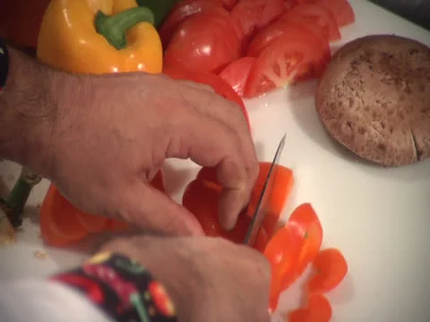 Red pepper getting sliced at cutting board, with refocus Video stock 26190708