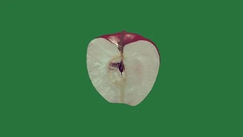 A red pepper on green screen and an apple is sliced into pieces in half cut Video stock 335130428