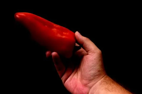 Red pepper in a hand Stock Photos
