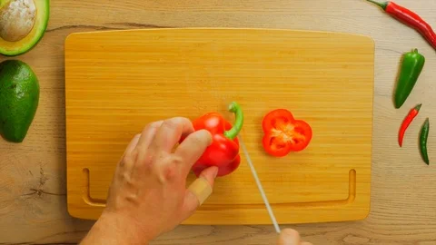 Red pepper opening and cleaning seeds Stockbeeldmateriaal 107539024