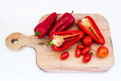 Red pepper, pepper in cut, cherry tomatoes on white background Stock Photos