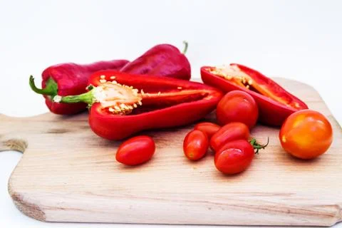 Red pepper, pepper in cut, cherry tomatoes on white background Stock Photos