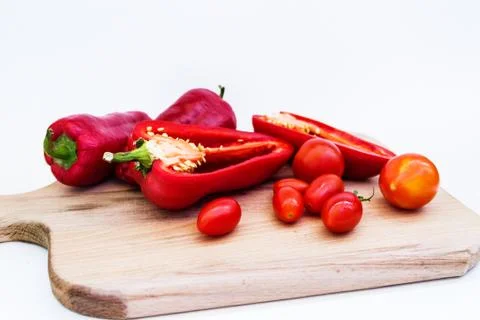 Red pepper, pepper in cut, cherry tomatoes on white background Stock Photos
