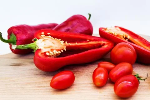 Red pepper, pepper in cut, cherry tomatoes on white background Stock Photos