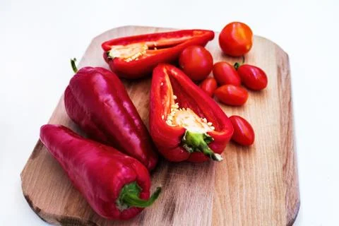 Red pepper, pepper in cut, cherry tomatoes on white background Stock Photos