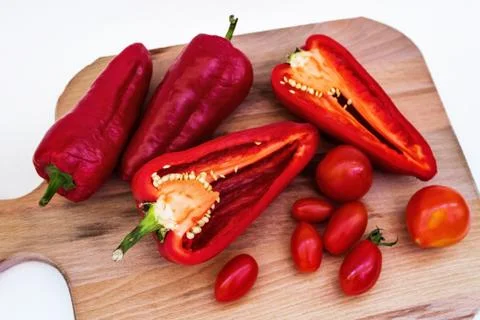 Red pepper, pepper in cut, cherry tomatoes on white background Stock Photos