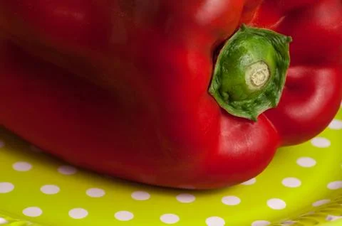 Red pepper on plate with polka dots Stock Photos