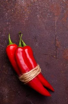 Red pepper pod on a rusty brown metal background. Stock Photos