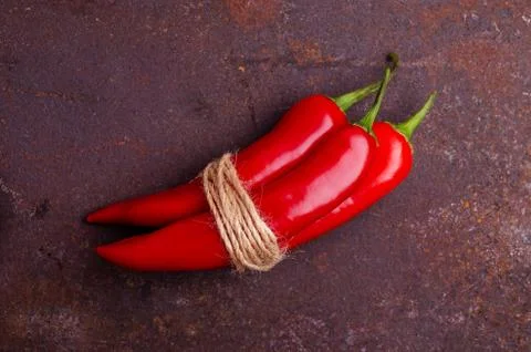 Red pepper pod on a rusty brown metal background. Stock Photos