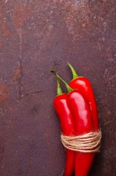 Red pepper pod on a rusty brown metal background. Stock Photos