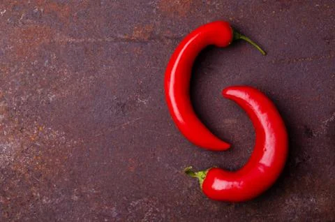 Red pepper pod on a rusty brown metal background. Stock Photos