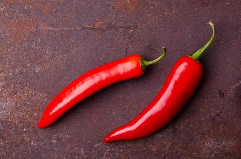 Red pepper pod on a rusty brown metal background. Stock Photos