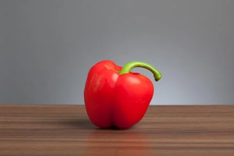 Red pepper, raw, on table Stock Photos