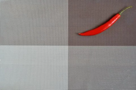 Red pepper on a rectangular background of gray, brown and white Stock Photos