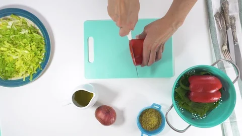 Red pepper slices on a cutting board. Vegetable salad on a plate Stock Footage 118512117