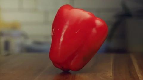Red pepper spinning on a table in slow motion Stock Footage 152904788
