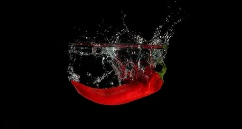 Red pepper splashed into water 写真素材