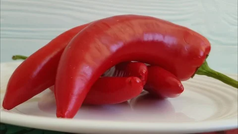 Red pepper turns on a plate Stock Footage 87031578