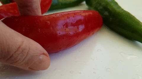 Red pepper wet on white background hand Stock Footage 88292864