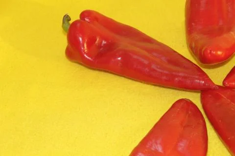 Red pepper on a yellow background Stock Photos