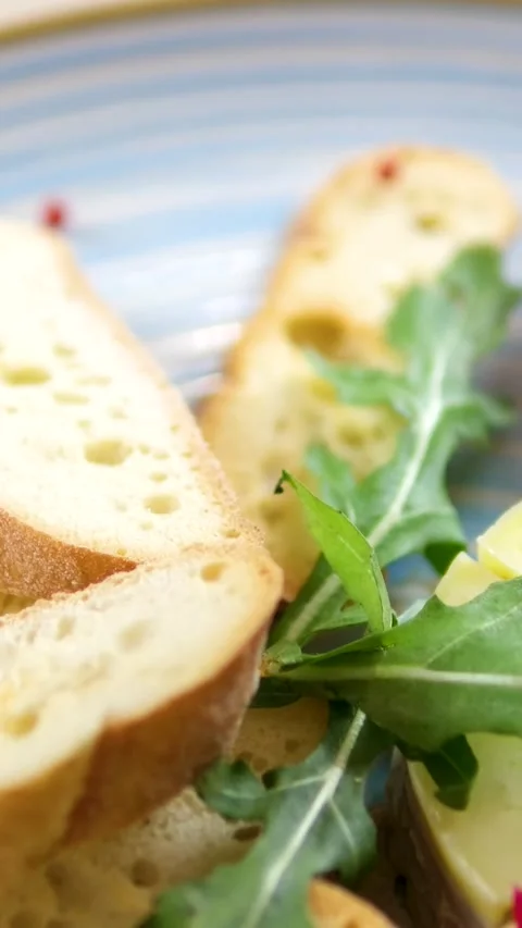 Red peppercorns, pate and small croutons, sprinkle with cherry sauce on a blue Stock Footage 323526463