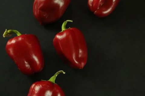 Red peppers on black background Stockfoto's