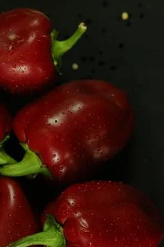 Red peppers on black background Stock Photos