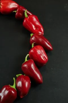 Red peppers on black background Stockfoto's