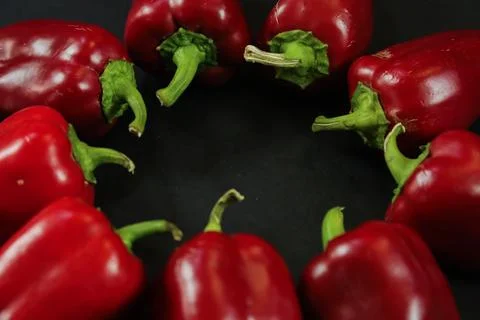 Red peppers on black background Stockfoto's