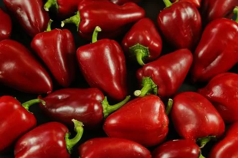 Red peppers on black background Stockfoto's