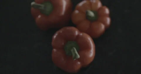 Red peppers falling into water with a splash Stock Footage 146950328