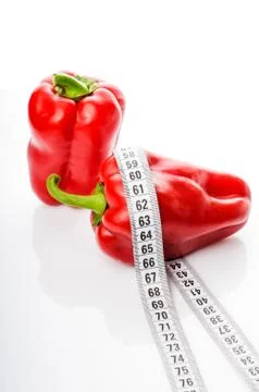 Red peppers in measure tape Фото