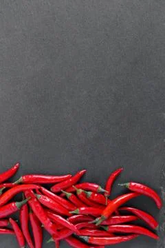Red peppers on stone background Stock-Fotos