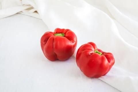 Red peppers on table background and white fabric Stock Photos