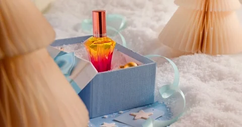 Red perfume is placed inside lovely Christmas gift boxes. Vídeo Stock 346060544