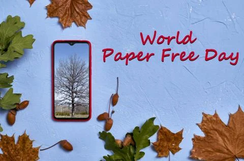 Red phone with a tree on the screen flat lay.World Paper Free Day text Stock Photos