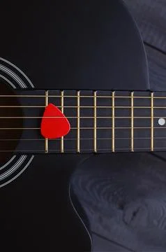 Red pick on fretboard Stock Photos