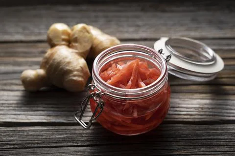 Red pickled ginger placed on an old wooden background. Stock Photos
