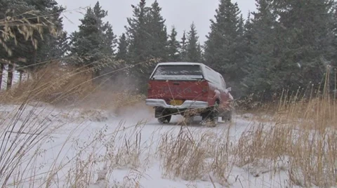 Red Pickup Drives Around Corner in Snowstorm Blizzard Stock Footage 8951623