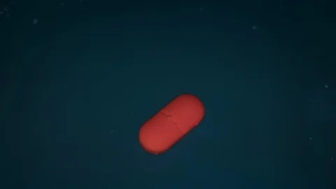 Red Pill or Tablet Dissolving Process in Liquid on Blue Background. Timelapse Stock Footage 116927276